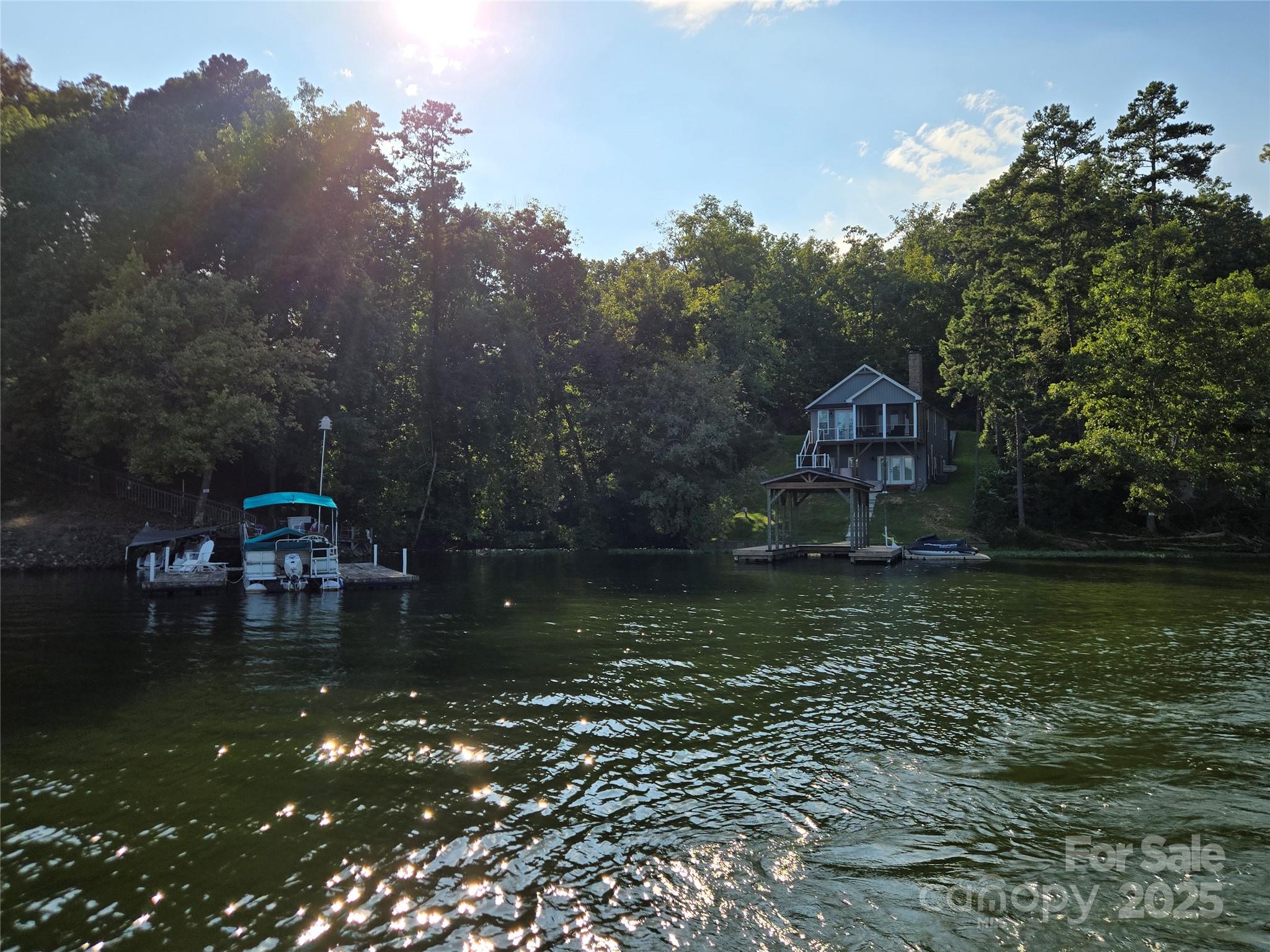 0 Shoreline Road, Unit 107 Badin Lake, NC 28127 - Photo 35 of 48 a view of a lake with a house in the background