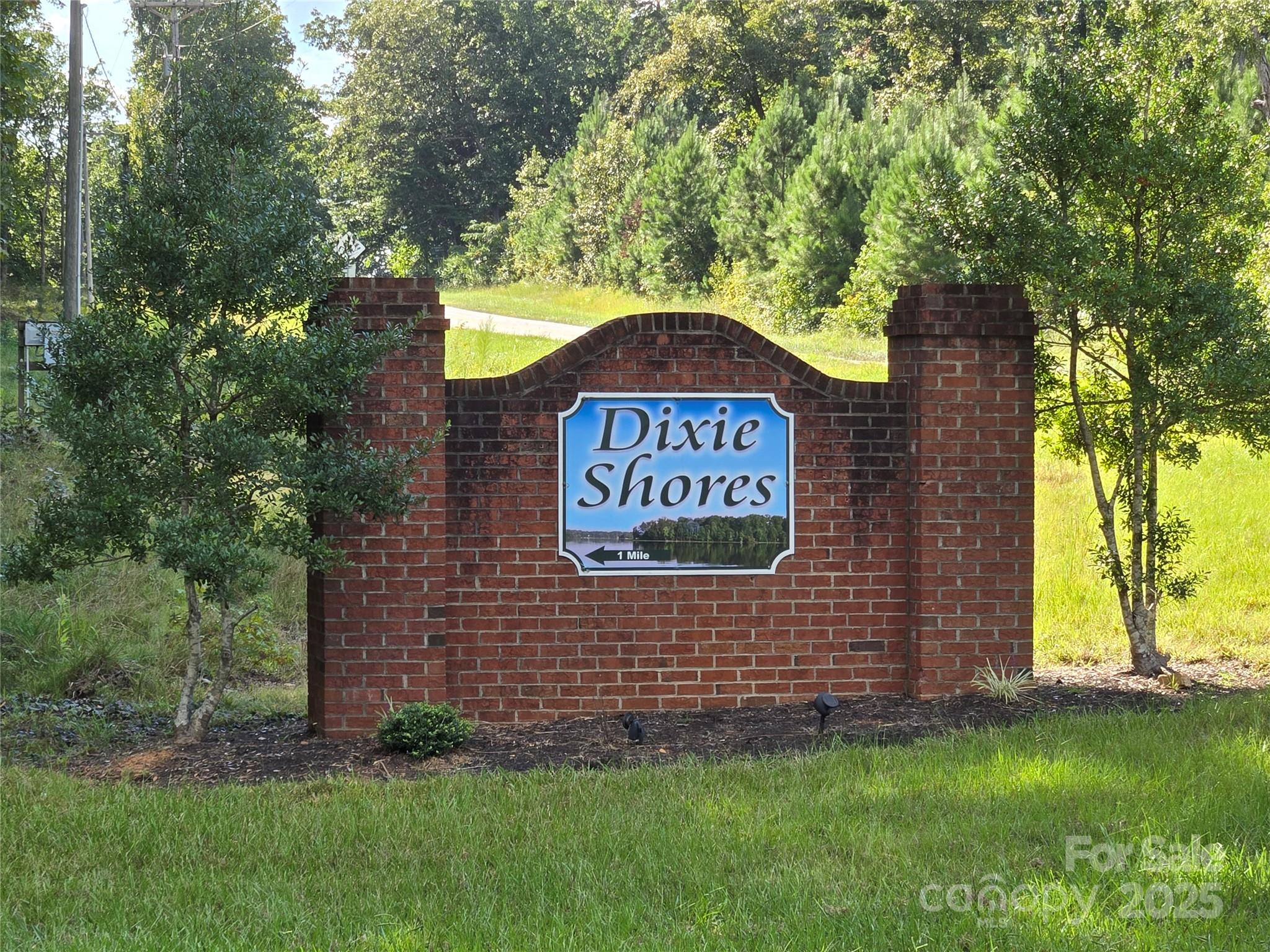 0 Shoreline Road, Unit 107 Badin Lake, NC 28127 - Photo 4 of 48 a sign that is sitting on a brick wall