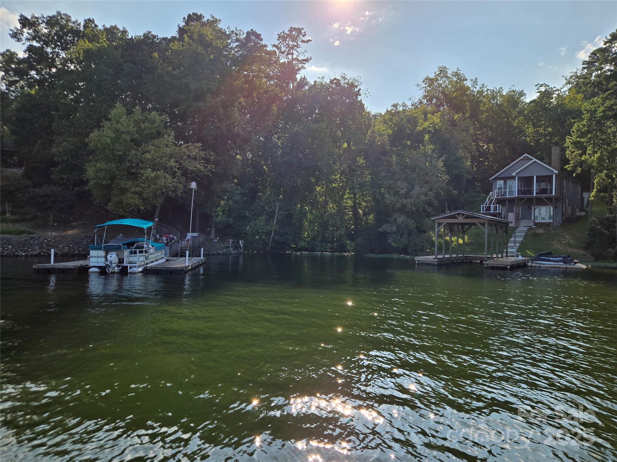 0 Shoreline Road, Unit 107 Badin Lake, NC 28127 - Photo 42 of 48 a view of a lake with a house in the background