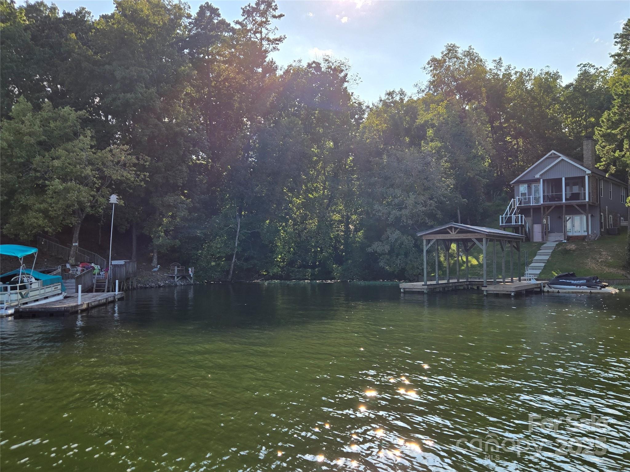0 Shoreline Road, Unit 107 Badin Lake, NC 28127 - Photo 43 of 48 a view of a lake with a house in the background