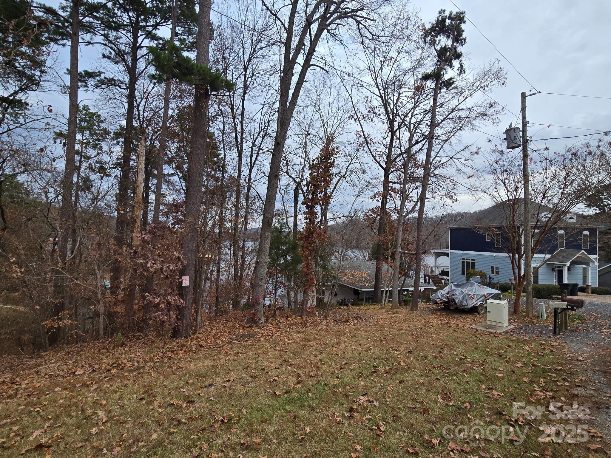 0 Shoreline Road, Unit 107 Badin Lake, NC 28127 - Photo 10 of 48 a view of a backyard that has a large tree