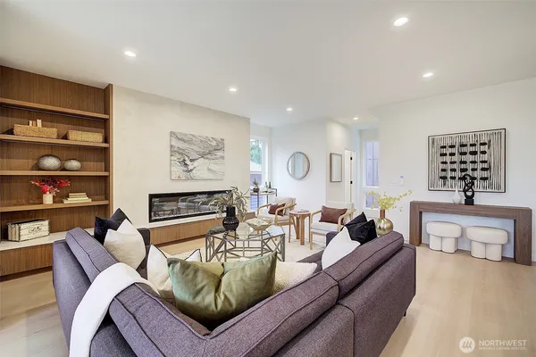 a living room with furniture a kitchen island a sink and a stove