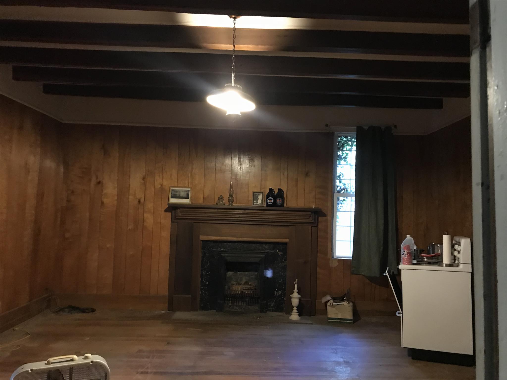 148 Hayes Ridge Road Lancaster, TN 38569 - Photo 3 of 9 a living room with a fireplace and a wooden floor