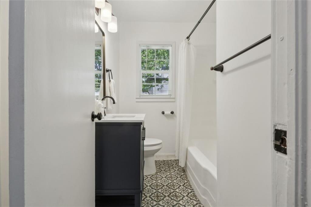 2130 Main Street Northwest Atlanta, GA 30318 - Photo 12 of 17 a bathroom with a sink a toilet a window and shower