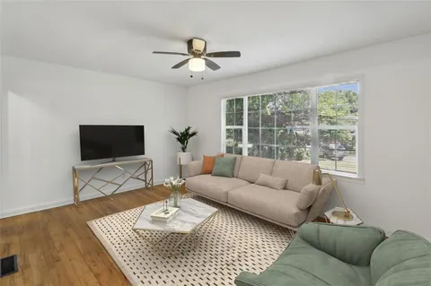 a living room with furniture and a flat screen tv