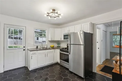a kitchen with stainless steel appliances a refrigerator sink and stove