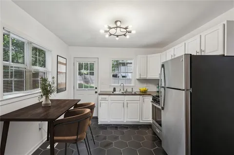 a kitchen with granite countertop a sink stainless steel appliances and cabinets