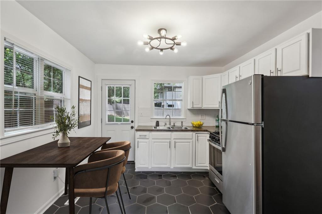 2130 Main Street Northwest Atlanta, GA 30318 - Photo 8 of 17 a kitchen with granite countertop a sink stainless steel appliances and cabinets