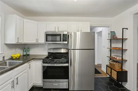 a kitchen with stainless steel appliances a refrigerator stove and microwave