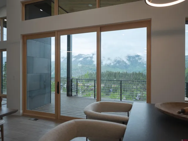 a living room with furniture and a floor to ceiling window