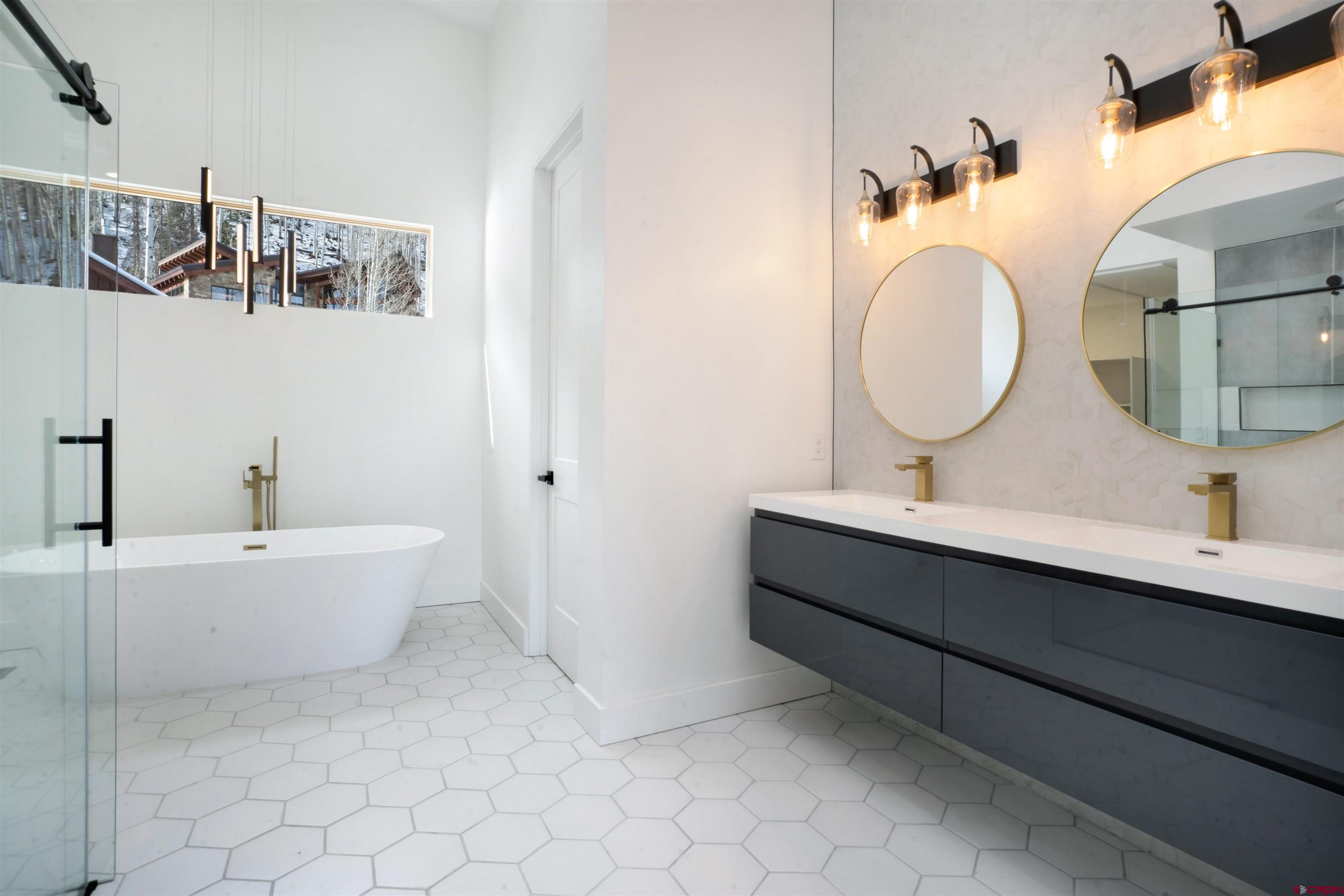 9 Cherub Court Durango, CO 81301 - Photo 14 of 45 a bathroom with a double vanity sink mirror and bathtub