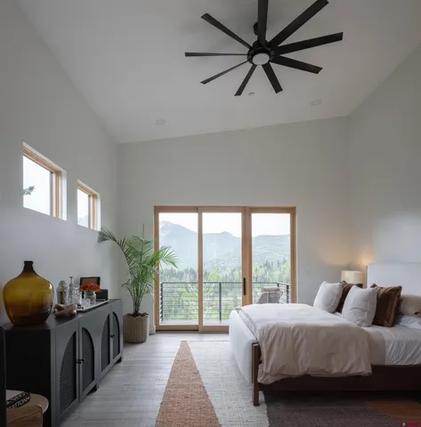 a bedroom with a bed and glass windows