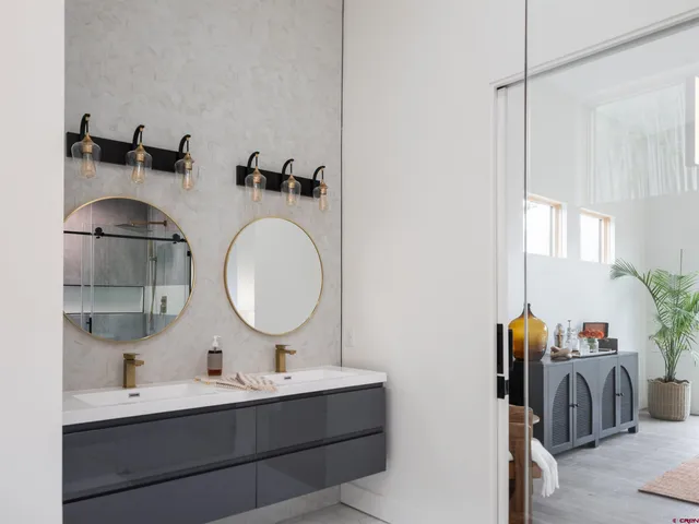 a bathroom with a double vanity sink and mirror