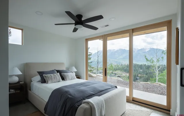 a bedroom with a large bed and a large window