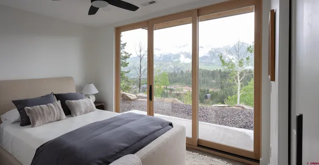 a bedroom with a large bed and a balcony view