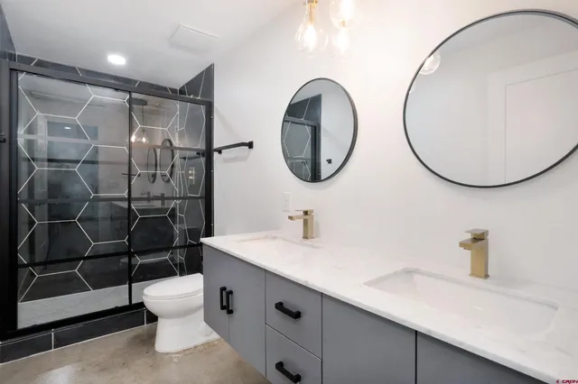 a bathroom with a sink mirror vanity and toilet