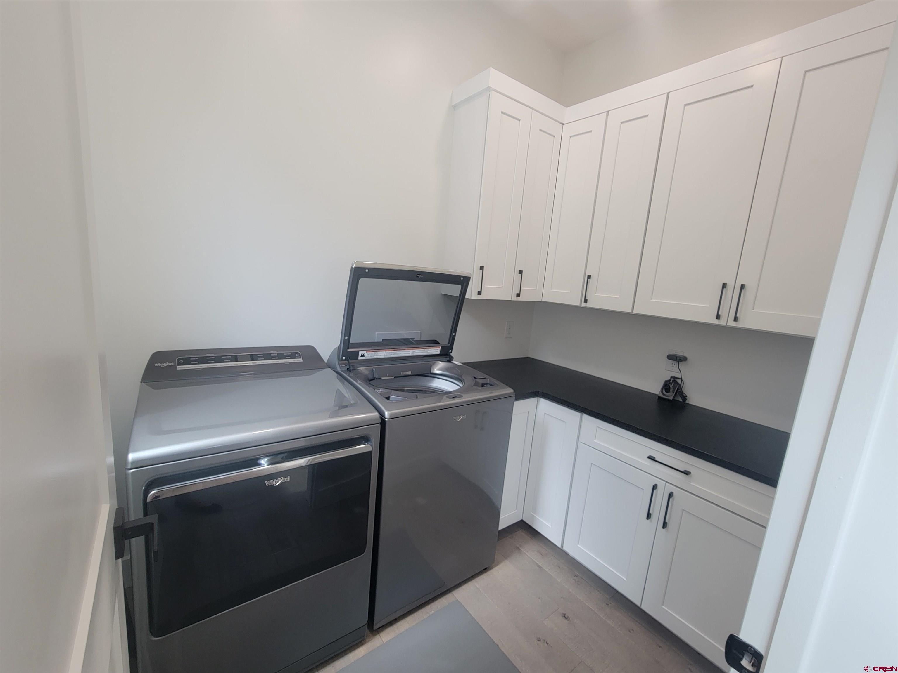 9 Cherub Court Durango, CO 81301 - Photo 28 of 45 a kitchen with white cabinets and white appliances