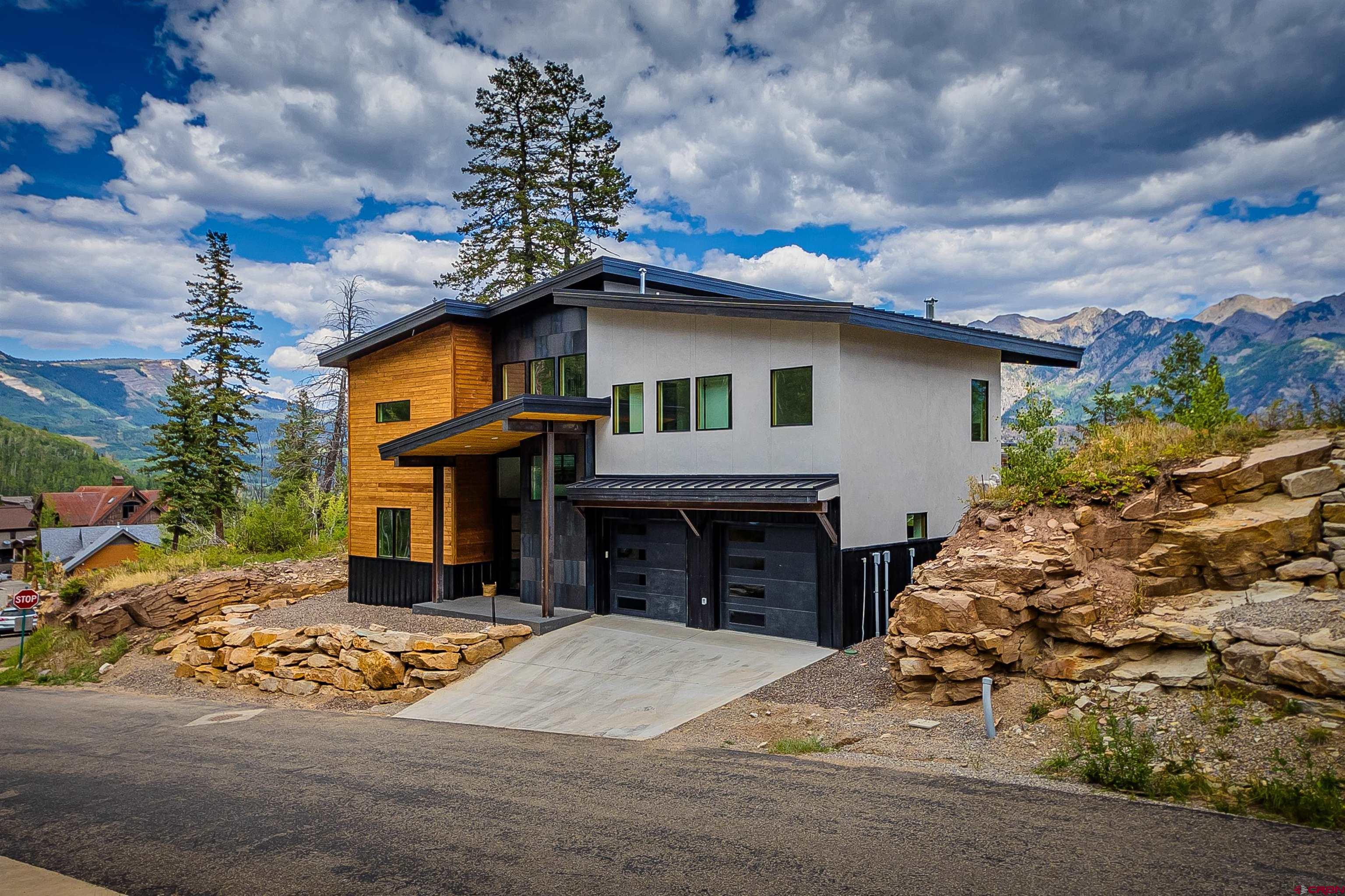 9 Cherub Court Durango, CO 81301 - Photo 31 of 45 a front view of a house with a yard and garage