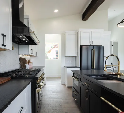 a kitchen with stainless steel appliances granite countertop a sink stove and refrigerator