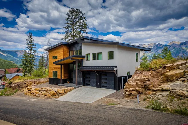 a view of a patio with couches under an umbrella