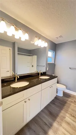 a large bathroom with a granite countertop sink and a mirror