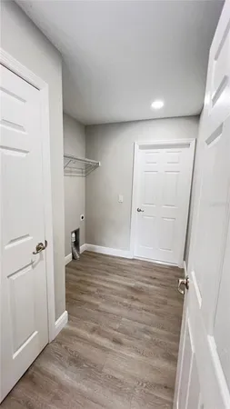 an empty room with wooden floor and closet