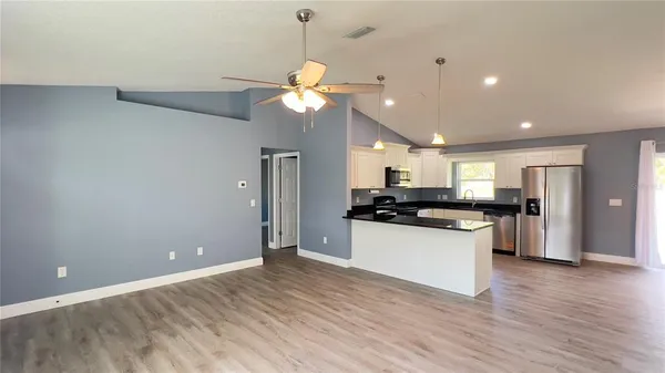 a view of a kitchen with a sink stainless steel appliances and cabinets