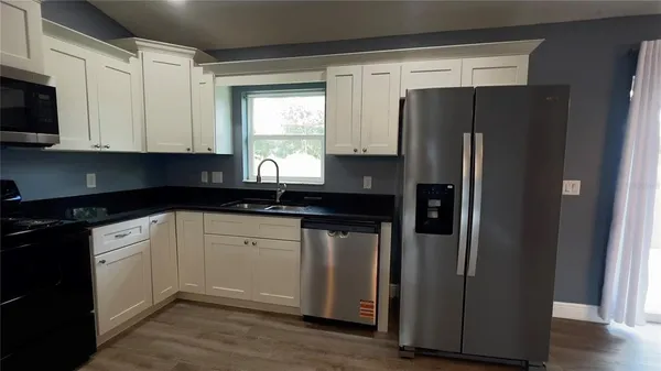 a kitchen with a refrigerator and a sink