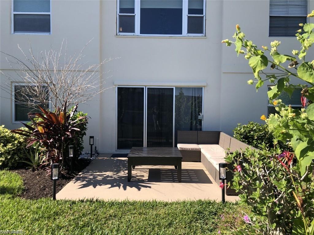 1000 Manatee Road, Unit A105 Naples, FL 34114 - Photo 14 of 22 a front view of a house with a yard