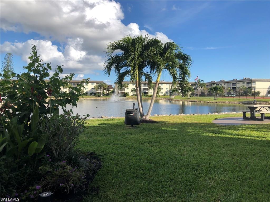 1000 Manatee Road, Unit A105 Naples, FL 34114 - Photo 17 of 22 a view of a lake with a big yard