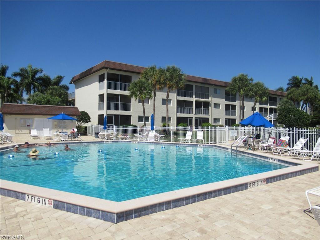 1000 Manatee Road, Unit A105 Naples, FL 34114 - Photo 18 of 22 a view of pool with outdoor seating