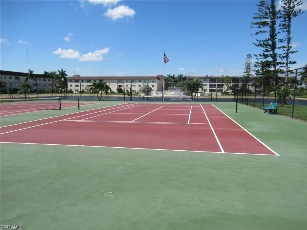 1000 Manatee Road, Unit A105 Naples, FL 34114 - Photo 20 of 22 a view of an outdoor space and tennis court