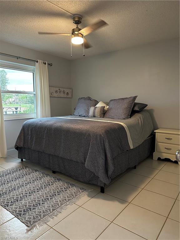 1000 Manatee Road, Unit A105 Naples, FL 34114 - Photo 2 of 22 a bedroom with a bed and a chandelier