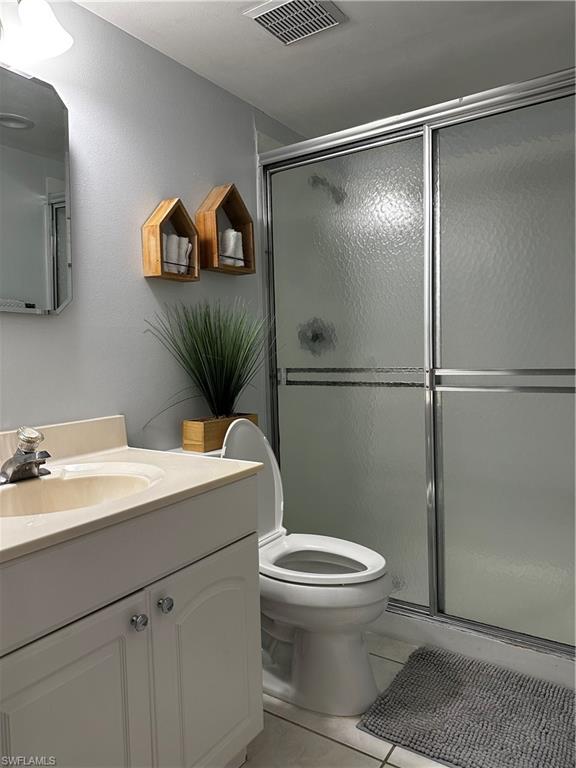 1000 Manatee Road, Unit A105 Naples, FL 34114 - Photo 5 of 22 a bathroom with a granite countertop sink mirror vanity and toilet