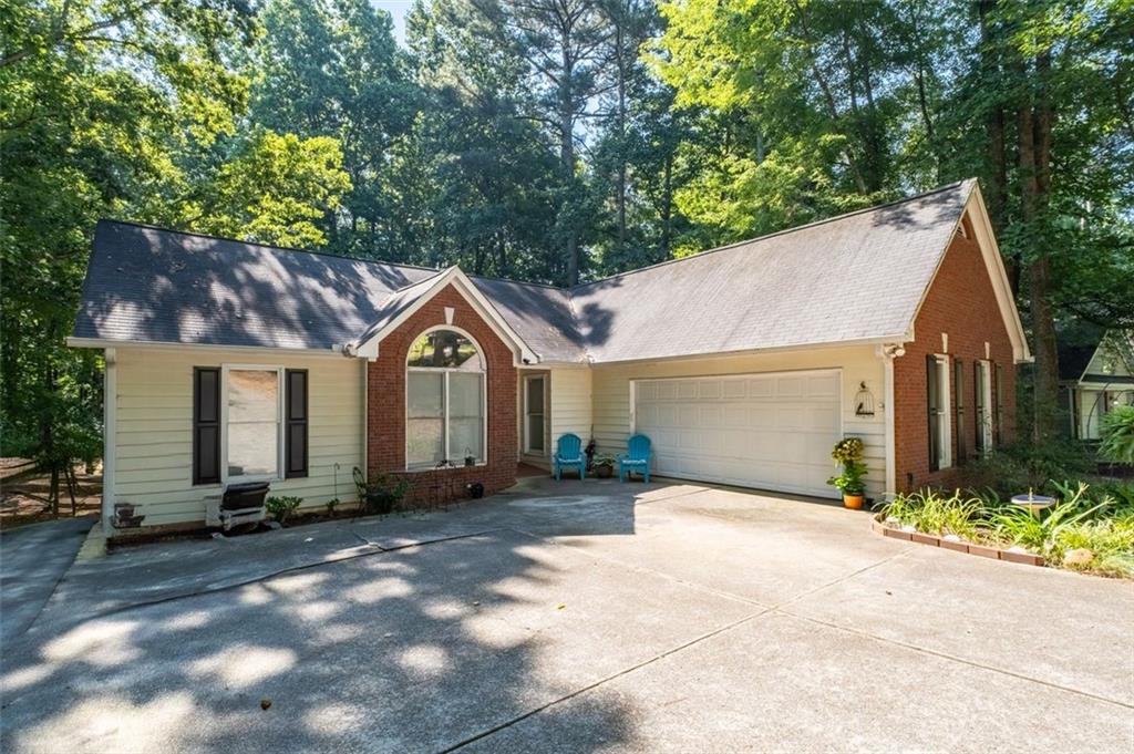 2030 Buford Dam Road Buford, GA 30518 - Photo 1 of 1 a view of a house with a yard plants and a small yard