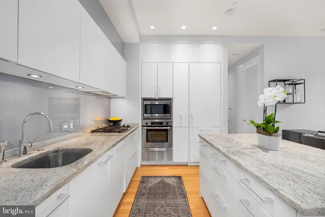a kitchen with stainless steel appliances granite countertop a sink and stove
