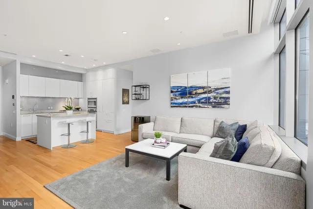 a living room with furniture and kitchen view