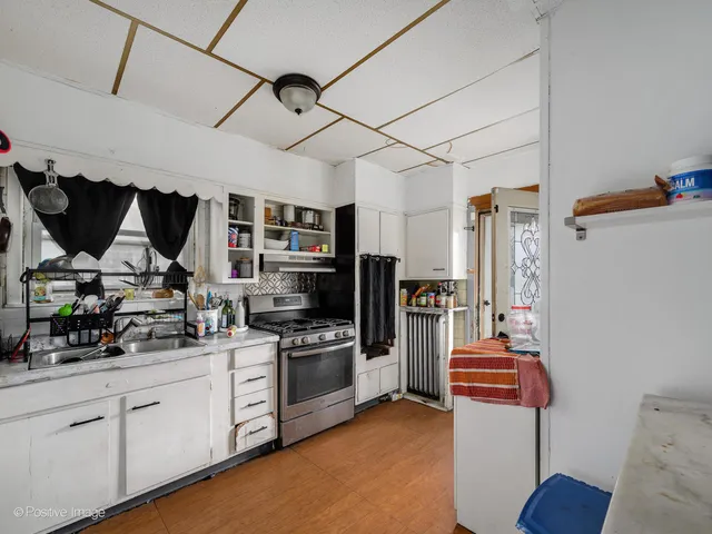 a kitchen with stainless steel appliances kitchen island granite countertop a refrigerator and a stove top oven