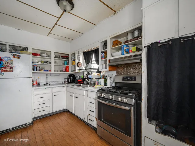 a kitchen with stainless steel appliances granite countertop a stove and cabinets