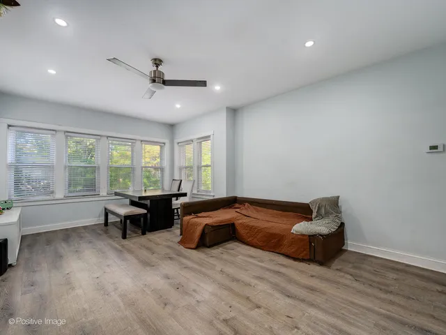 a spacious bedroom with a bed and a couch