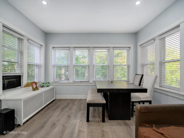 a kitchen with a table chairs and a window
