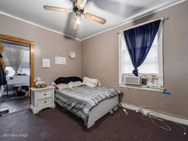 a bedroom with a bed closet and a window