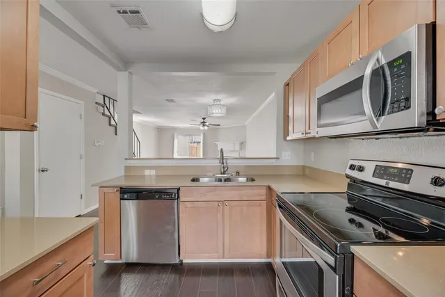 a kitchen with stainless steel appliances granite countertop a sink stove and cabinets