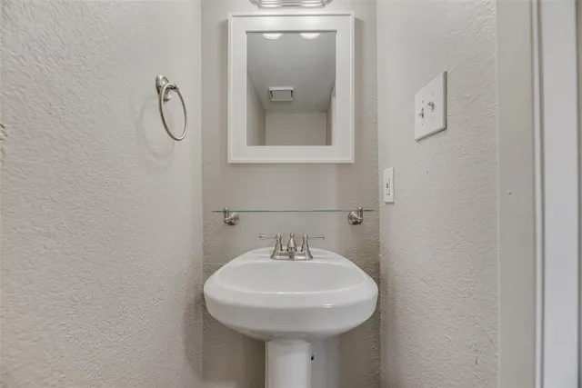 a bathroom with a sink and mirror