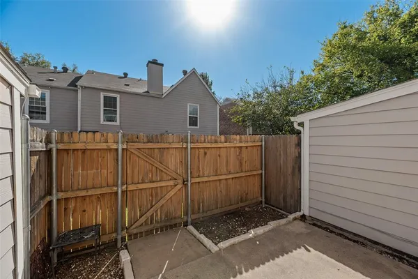 a view of a house with a door and wooden fence