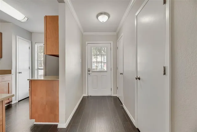 a view of a hallway with wooden floor
