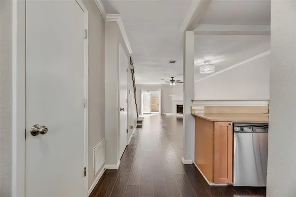 a view of a hallway with wooden floor and staircase