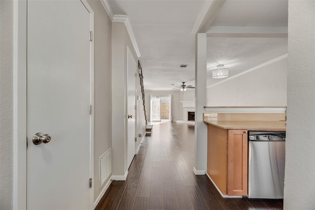 43 Abbey Road Euless, TX 76039 - Photo 6 of 22 a view of a hallway with wooden floor and staircase