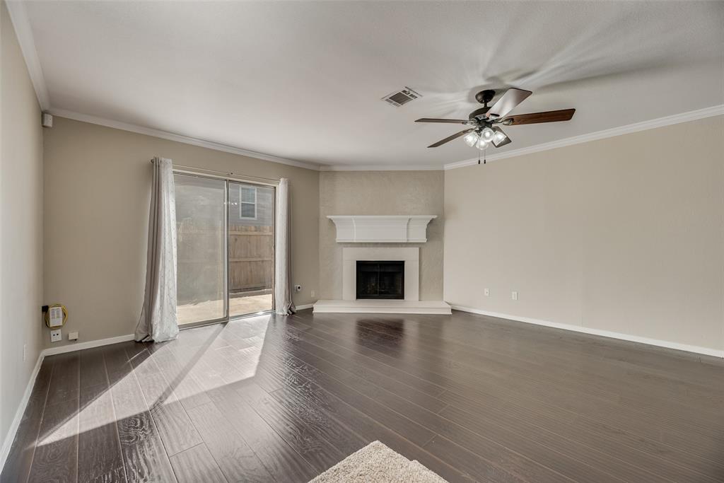 43 Abbey Road Euless, TX 76039 - Photo 10 of 22 a view of an empty room with a fireplace and a window