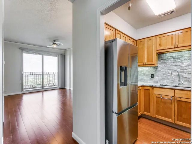 a kitchen with stainless steel appliances granite countertop a sink and a cabinets